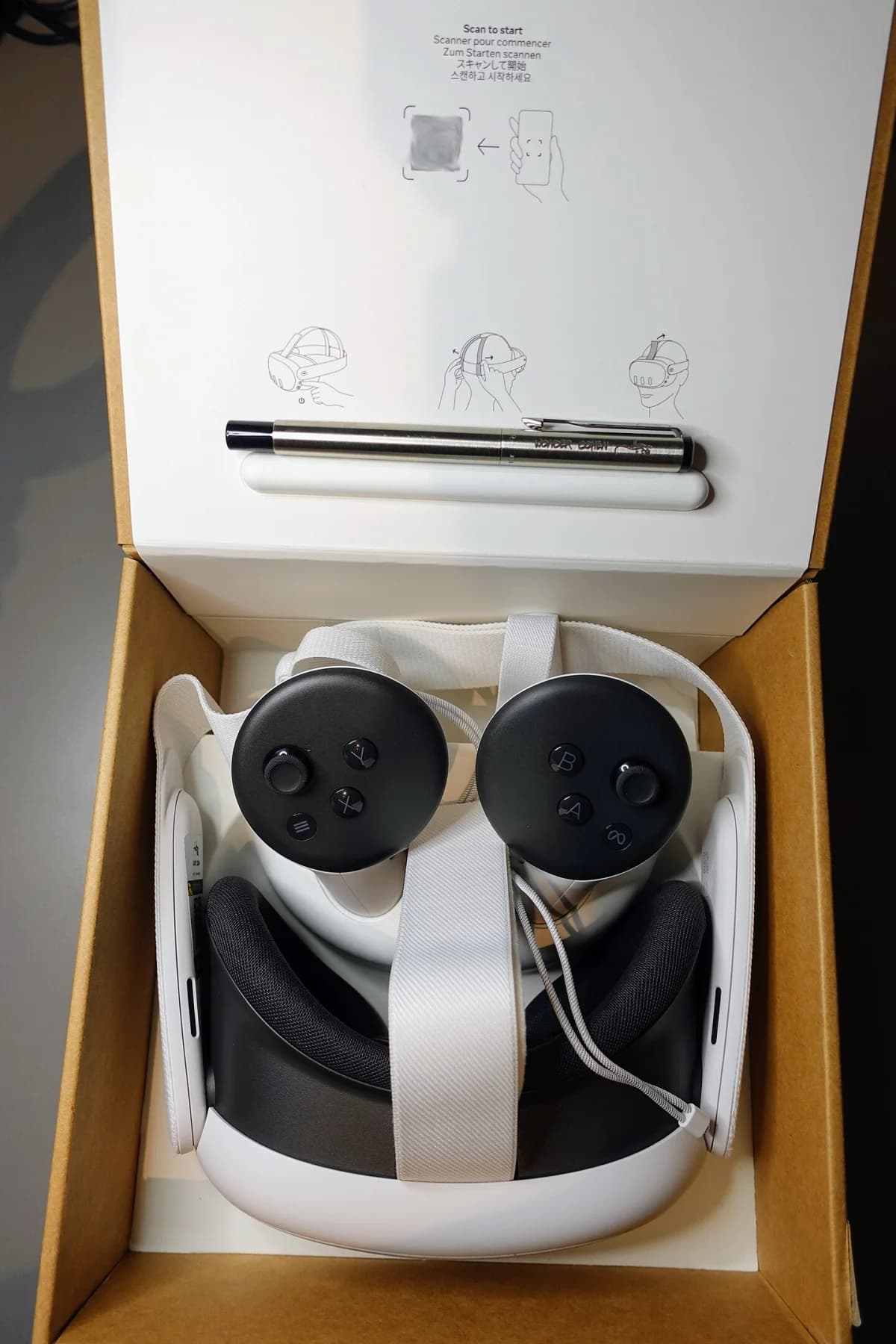 A Meta Quest 3 and controllers arranged in the product box.