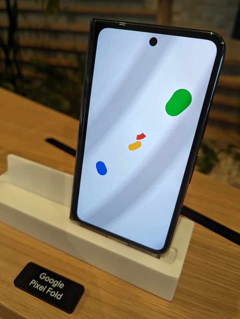 The cover display of a Google Pixel Fold on a stand.